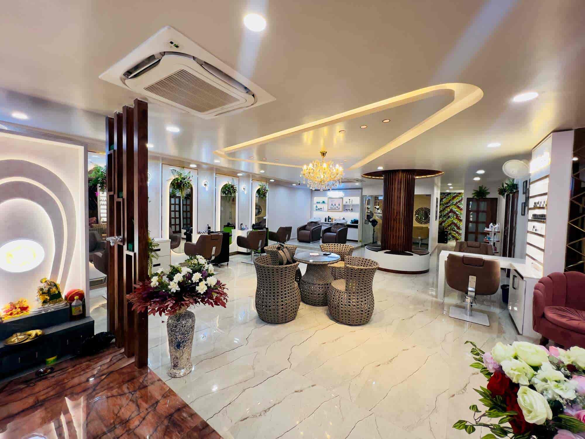 Full salon — chandelier, marble floors, styling stations, rattan lounge